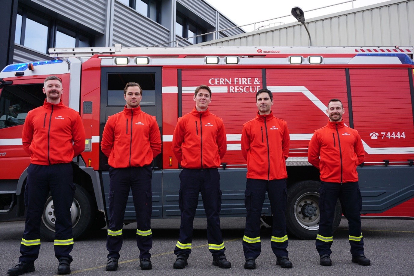 The recruits stand in front of a fire engine, coincidentally in height order from left (Rory tallest) to right.