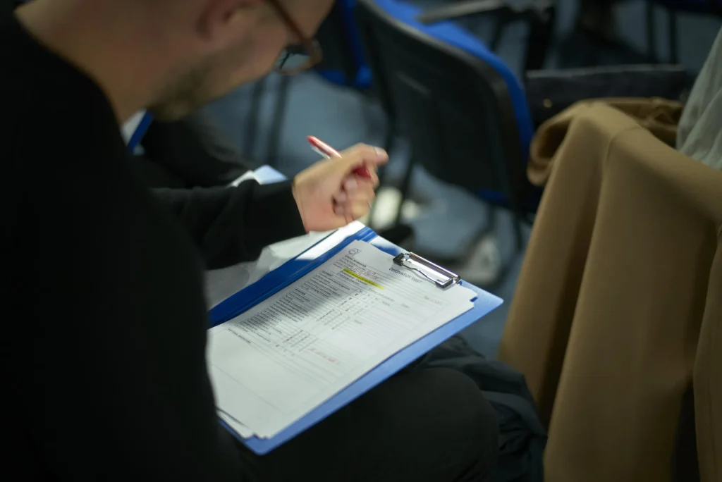 Volunteers fill in their feedback forms.